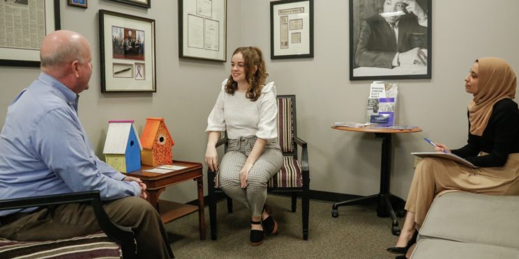 l-r Faulkner Law professor John Craft, and 3L law students Whittney Clark and Wala Hijaz pose for a mock client meeting at the Faulkner Law's Elder Law Clinic lobby